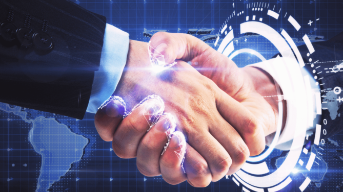 Business executives shaking hands through a digital portal